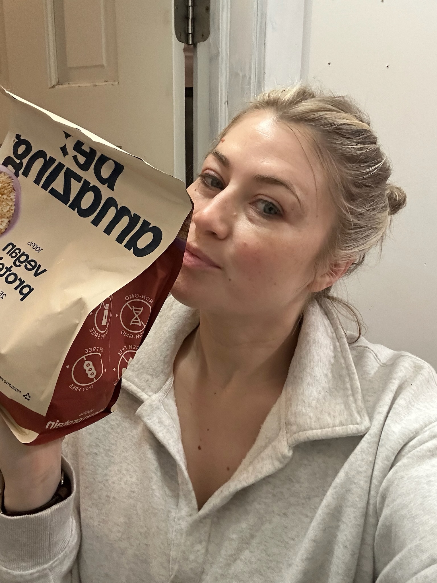 Mom holding a bag of Amazon protein snacks, easy high protein food option for busy moms and everyday snacking