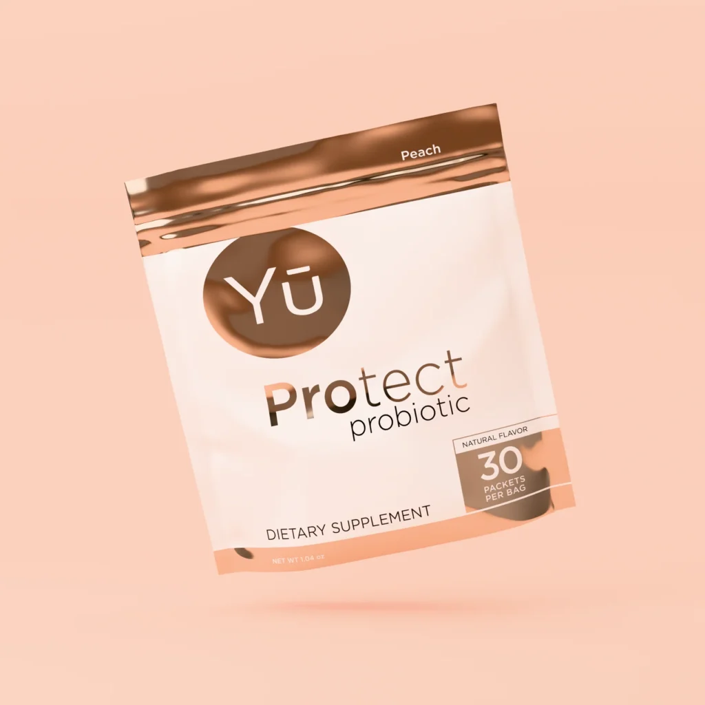 Yū Nutrition Protect Probiotic supplement packets in peach flavor, gut health and metabolism support used in a busy mom weight loss and wellness routine.